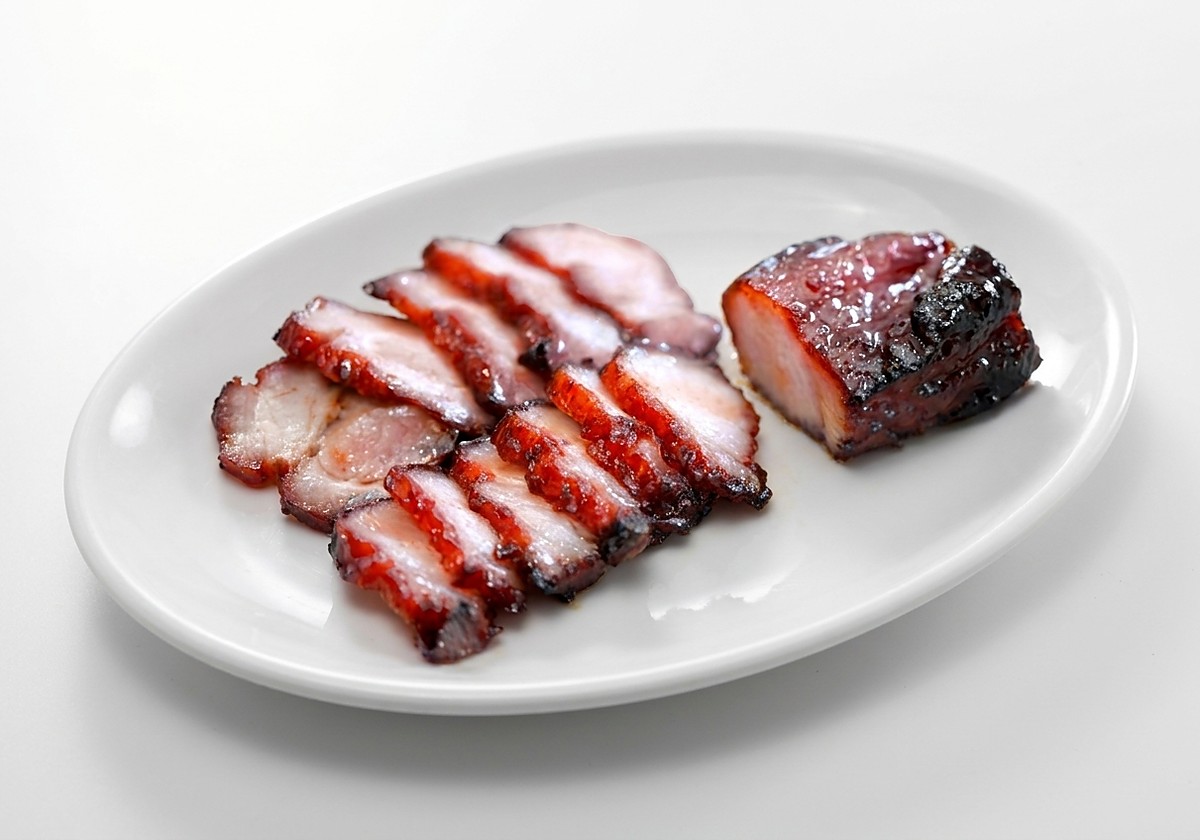 Guan Chee char siew, sliced and plated with a whole glazed piece