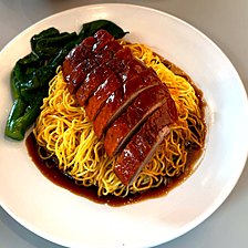 Roast duck on egg noodles with kai lan